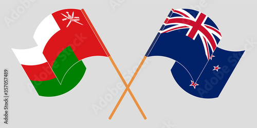 Crossed and waving flags of Oman and New Zealand