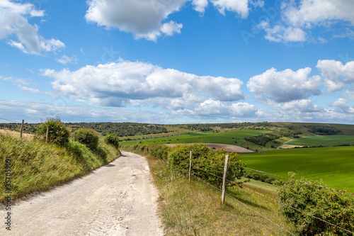 A footpath in the South Downs in Sussex  with a blue sky overhead