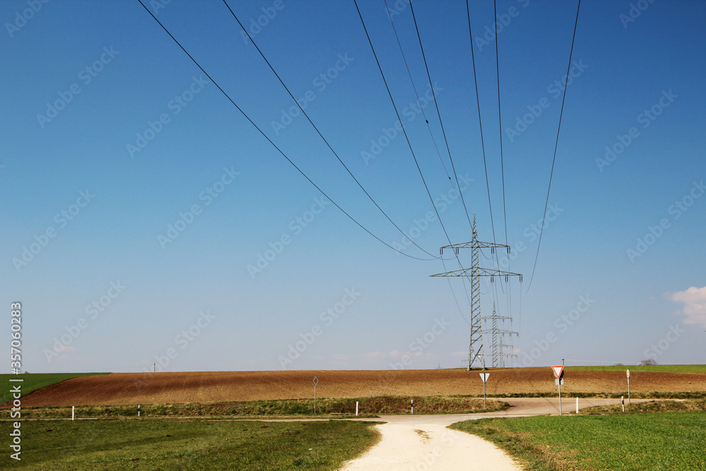 Electricity cable lines against bright blue sky