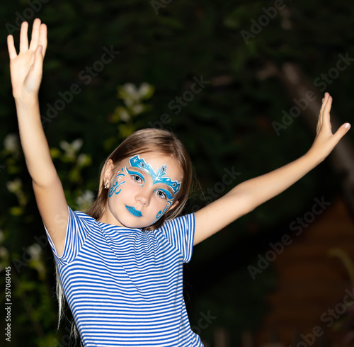 Girl with blue eyes and face painting  aqua mask