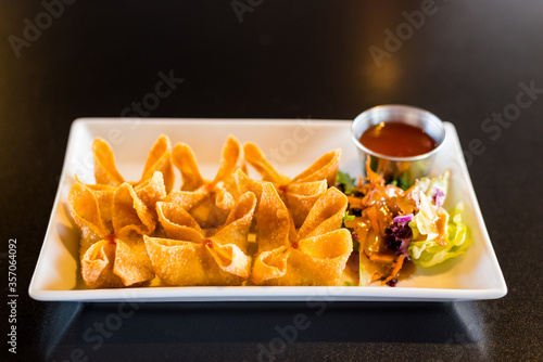 Crab Rangoon on a Tray with Side Salad.
