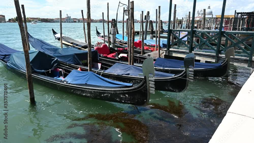 Venice, Italy - Gondolas waiting for tourists, moored near San Marco square Venice, Italy - Gondolas waiting for tourists, moored near San Marco square