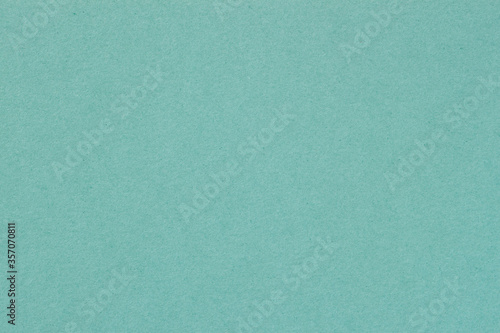 Texture of paper, light green mint color. Recyclable material. Fashionable modern background