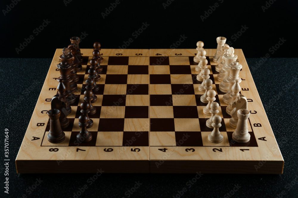 chess pieces on chessboard on dark background chess pieces on chessboard on dark background