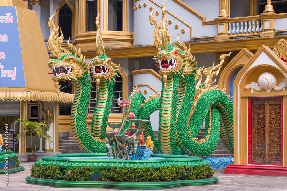 Fototapeta premium KRABI, THAILAND - 21 MARCH 2018: Four green dragons guarding the entrance to the Tiger Cave Temple.