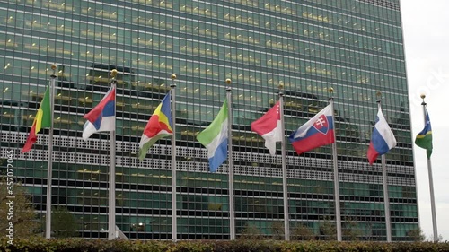 Multiple flags in front of the United Nations headquarters in New York City. Flags flying in the Wind in Slow Motion in Manhattan