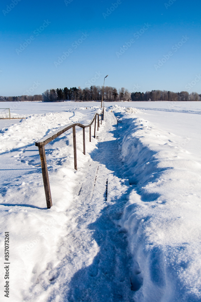 Frost snowflakes on wood, bridge with sun and snow Frost snowflakes on wood, bridge with sun and snow