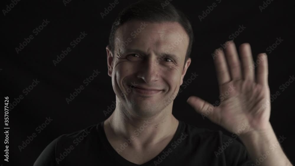 Successful rich man is smiling and hand weaving on black background. Businessman, leader concept with handsome guy. Successful rich man is smiling and hand weaving on black background. Businessman, leader concept with handsome guy.
