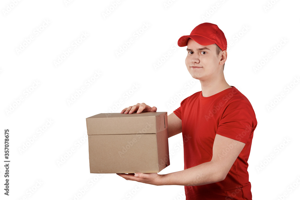 The guy from the delivery service in a cap with a parcel in his hands. The guy from the delivery service in a cap with a parcel in his hands.