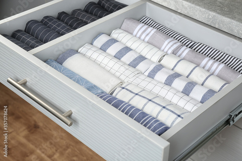Obraz na plátně Open drawer with folded towels. Order in kitchen