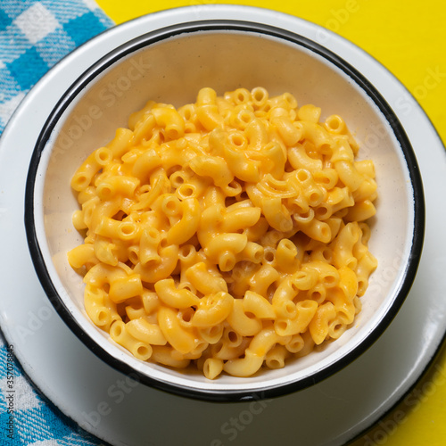 Creamy mac and cheese on yellow background