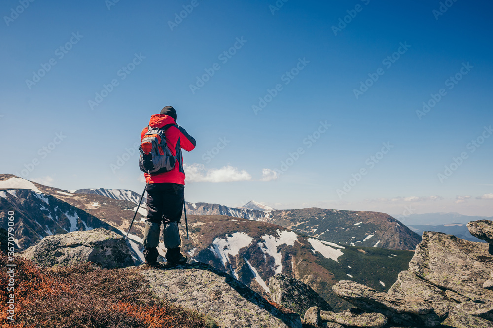 A man standing on a rocky hill