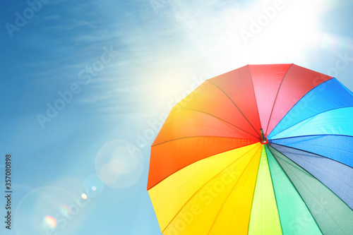 Φωτογραφία Modern color umbrella against blue sky. Sun protection