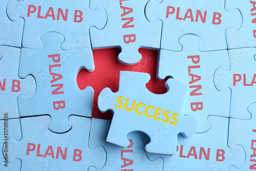 Light blue puzzle with phrases PLAN B and SUCCESS on red background, top view