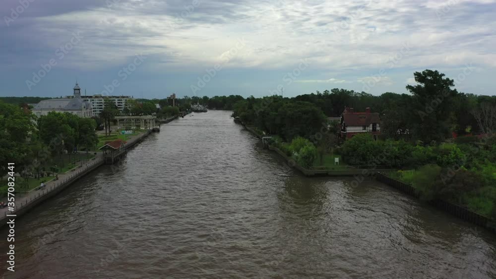 Aerial shot of river against sky, drone flying forward over water in city - Tigre, Argentina Aerial shot of river against sky, drone flying forward over water in city - Tigre, Argentina