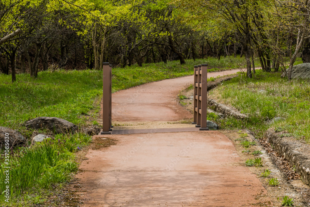 Sidewalk across wooden footbridge Sidewalk across wooden footbridge