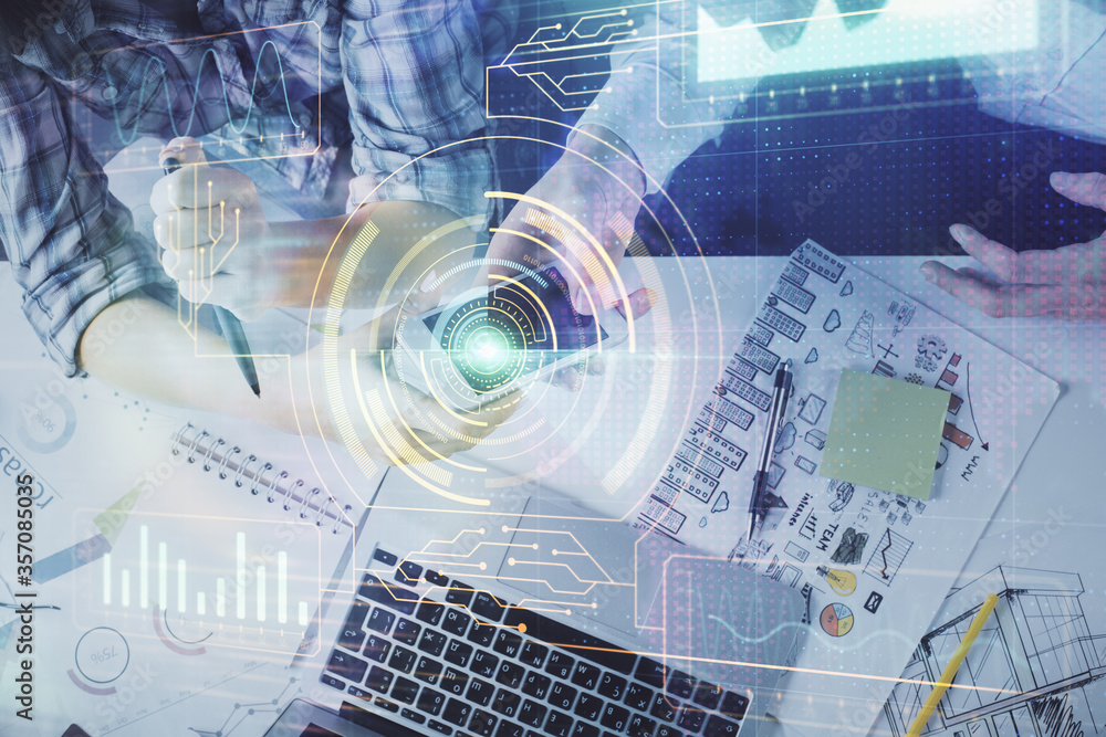 Double exposure of data theme hologram drawing and man and woman working together holding and using a mobile device. Double exposure of data theme hologram drawing and man and woman working together holding and using a mobile device.