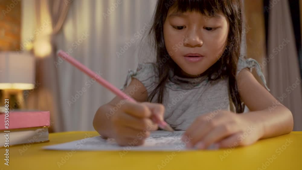 little asian kid studying by herself in the evening little asian kid studying by herself in the evening