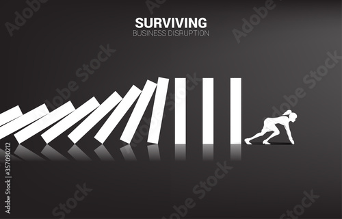 surviving business disruption. Silhouette of businesswoman ready to run away from domino collapse. Concept of business industry disrupt