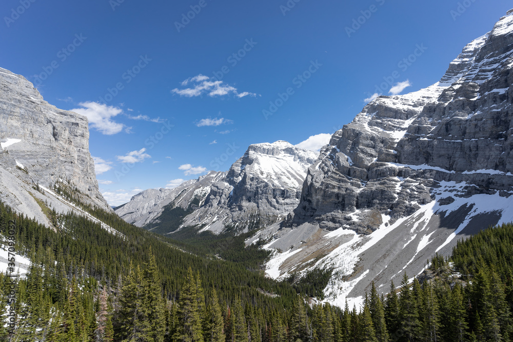 Alpine valley in Canadian Rockies with peaks, forest and snow, shot at Ribbon Falls Trail, Kananaskis, Alberta, Canada
