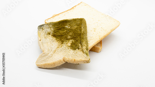 pile of nice buns with sliced moldy bread, isolated on a white background