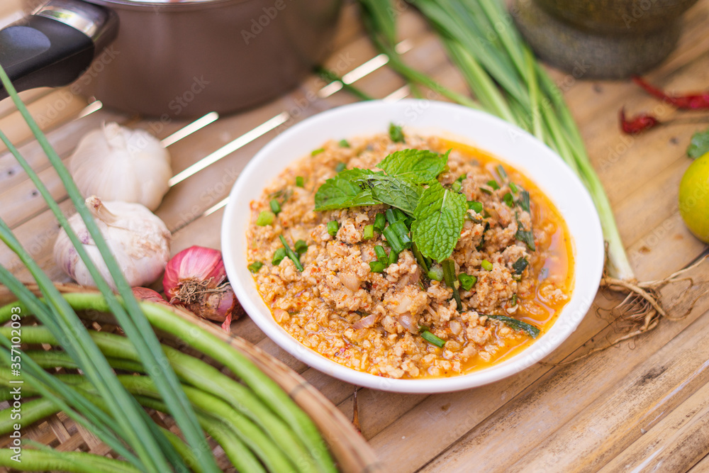 spicy minced meat salad on the wooden table,Thai food. spicy minced meat salad on the wooden table,Thai food.