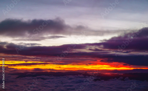 Stunning Colorful Sunset Above The Clouds Over Mountain Peaks