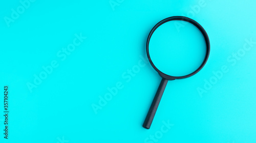 Wallpaper Mural Magnifying glass isolated on blue background Torontodigital.ca