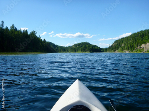 View from inside a white kayak, on a lake