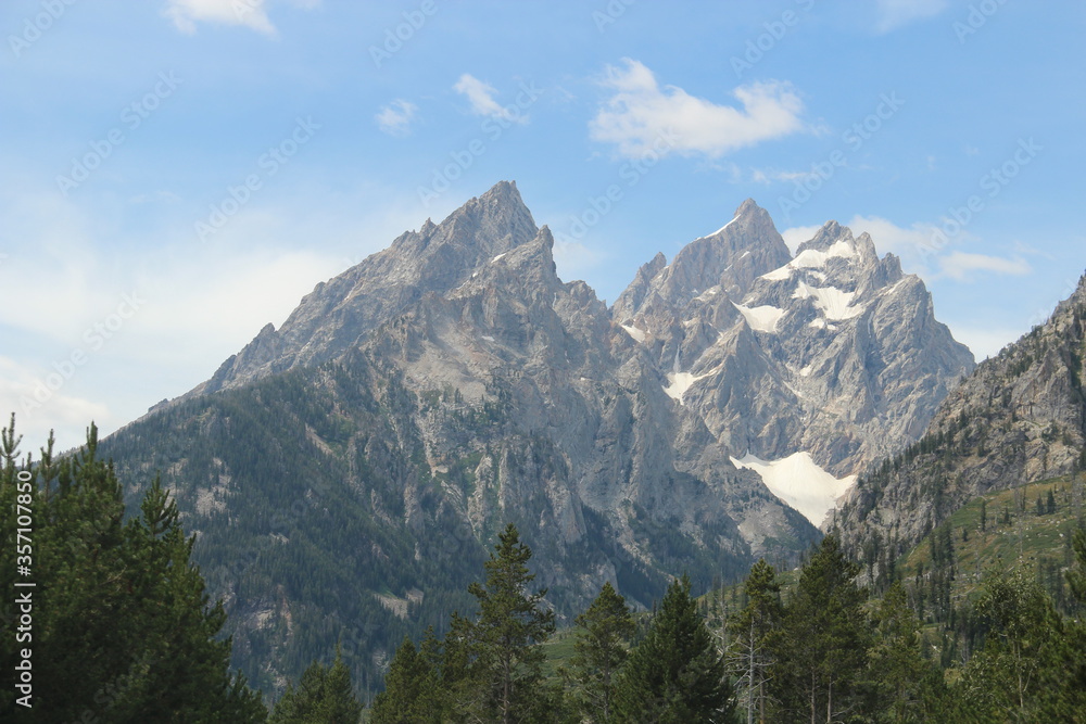 Grand teton in blue skies and some snow on top.