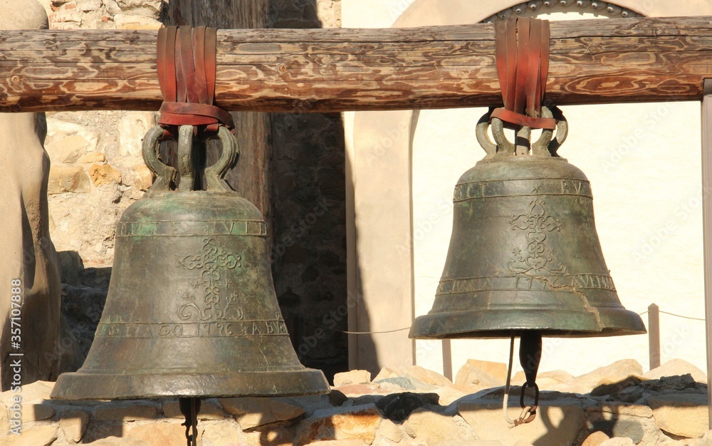 Two antique small and big bells. Two antique small and big bells.