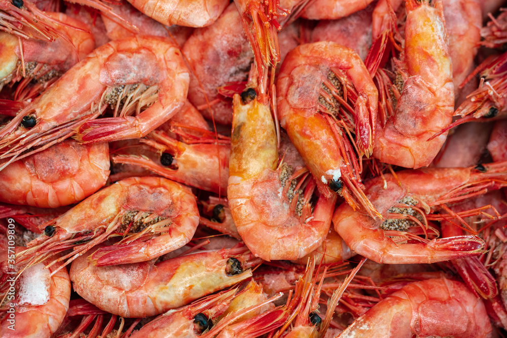 Lot of boiled-frozen wild shrimp with caviar cooked in sea water. Background of group small aquatic crustaceans. Prawn - Asian sea delicacy cuisine as an appetizer. Close-up flat lay of tasty seafood. Lot of boiled-frozen wild shrimp with caviar cooked in sea water. Background of group small aquatic crustaceans. Prawn - Asian sea delicacy cuisine as an appetizer. Close-up flat lay of tasty seafood.