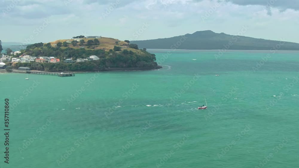 Aerial: Sailing Yacht in the Waitemata harbour. North Head and Rangitoto Island in the background. Auckland, New Zealand Aerial: Sailing Yacht in the Waitemata harbour. North Head and Rangitoto Island in the background. Auckland, New Zealand