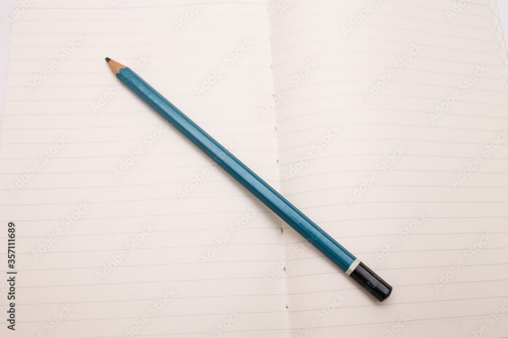 Open notebook on white background with pencil and rubber Open notebook on white background with pencil and rubber