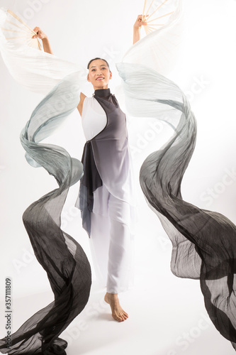 Adult woman dancing with long, swirling,black and white fabric.