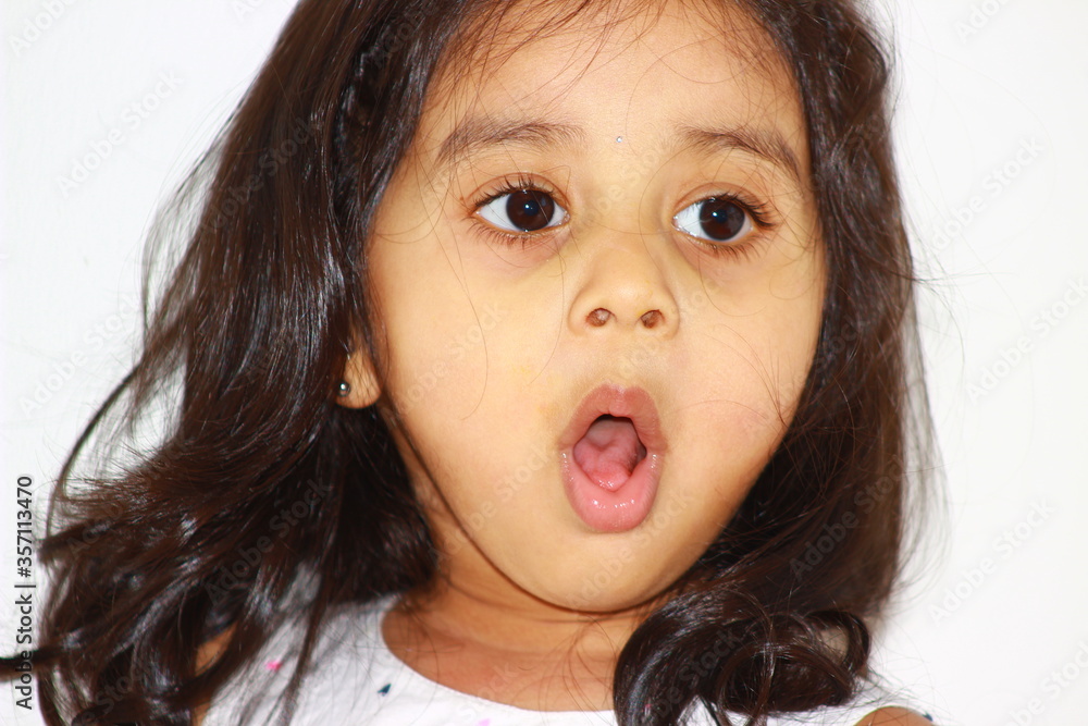close up of multiple cute expressions and emotions of a toddler girl. close up of multiple cute expressions and emotions of a toddler girl.
