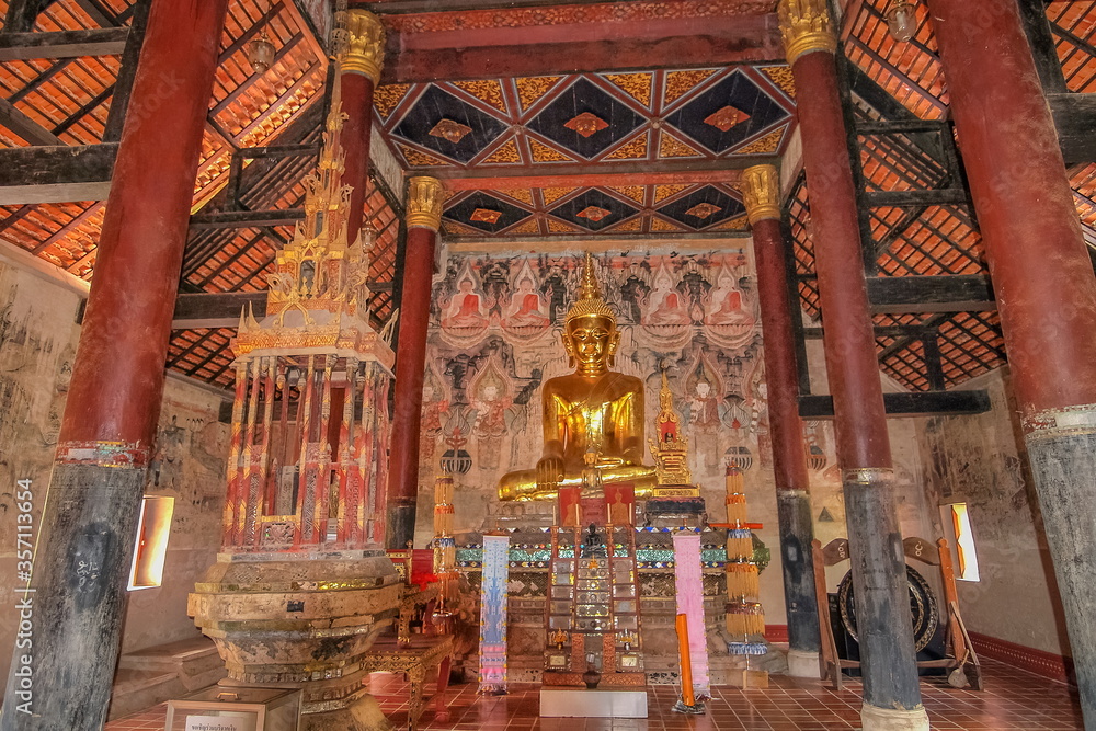 view of golden seated buddha statue in buddhist temple, Thai Lur style art 13th. Century., Wat Nong Bua, Tha Wang Pha District, Nan, northern of Thailand.