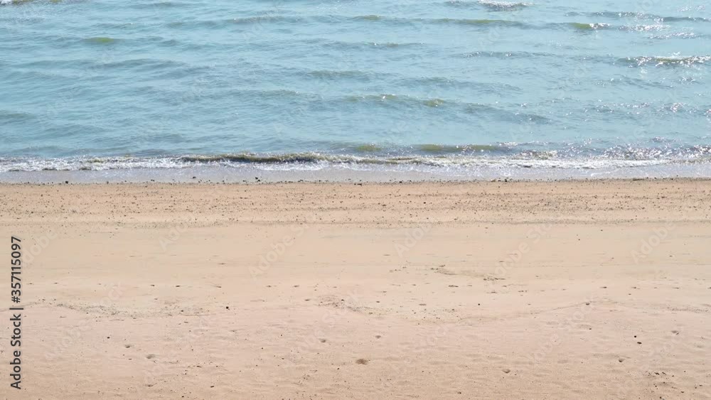 Soft wave with blue ocean on sandy beach with 4K resolution. Empty space can be used as background for display or montage your top view products. Soft wave with blue ocean on sandy beach with 4K resolution. Empty space can be used as background for display or montage your top view products.