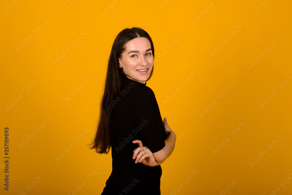 Obraz premium Wow. Beautiful female front portrait isolated on yellow studio backgroud. Young emotional surprised woman standing with open mouth. Human emotions, facial expression concept.
