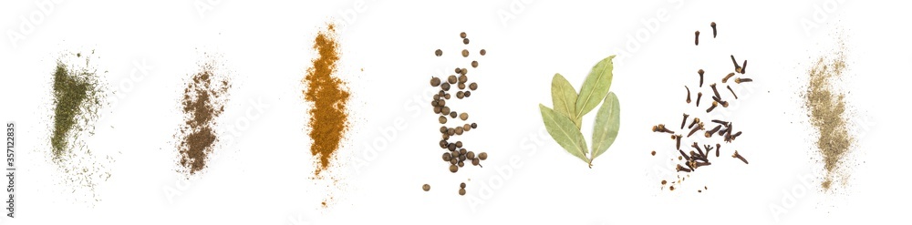 Set of various spices. Red and black pepper, dry cloves, Bay leaves, dried dill, peas. Close up. Isolated on a white background
