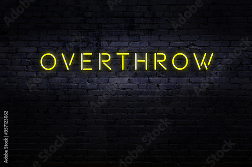 Billede på lærred Neon sign. Word overthrow against brick wall. Night view