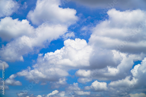 White clouds cumulus floating on blue sky for backgrounds concept © Apicha