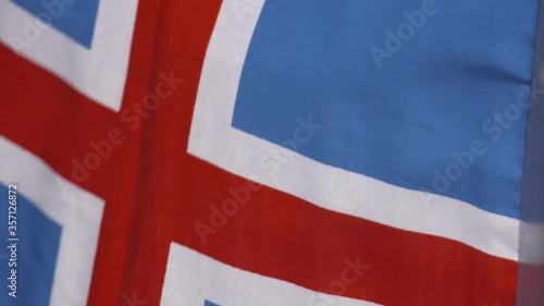 Iceland flag blowing in wind in slow motion close-up photo