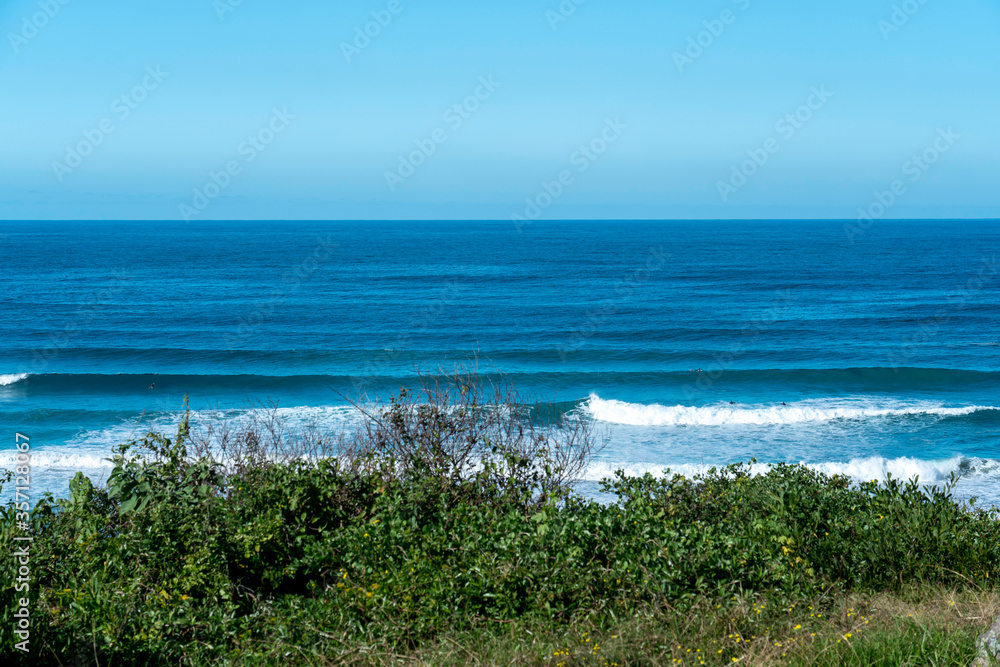 Lines of waves coming in at the beach, view from cliffs