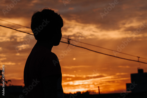 Silhouette of an Indian kid in front of the sunset