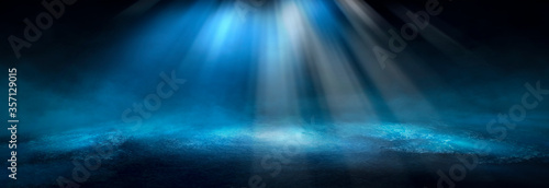 Dark dramatic abstract scene background. Neon glow reflected on the pavement. Smoke, smog and fog. Dark street, wet asphalt, reflections of rays in the water. Abstract dark blue background. 