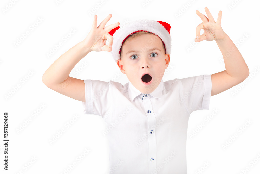 Dreamy caucasian Boy in disguise Santa Claus showing OK sign isolated on white background Dreamy caucasian Boy in disguise Santa Claus showing OK sign isolated on white background