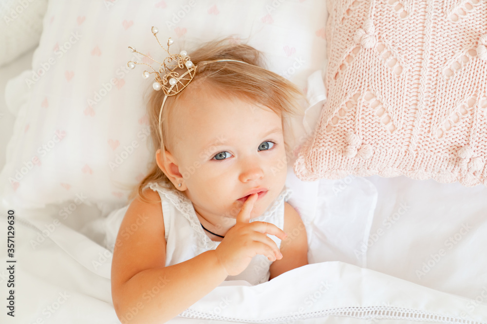 little girl sleeping in bed in bedroom with crown. Princess birthday party. little girl sleeping in bed in bedroom with crown. Princess birthday party.