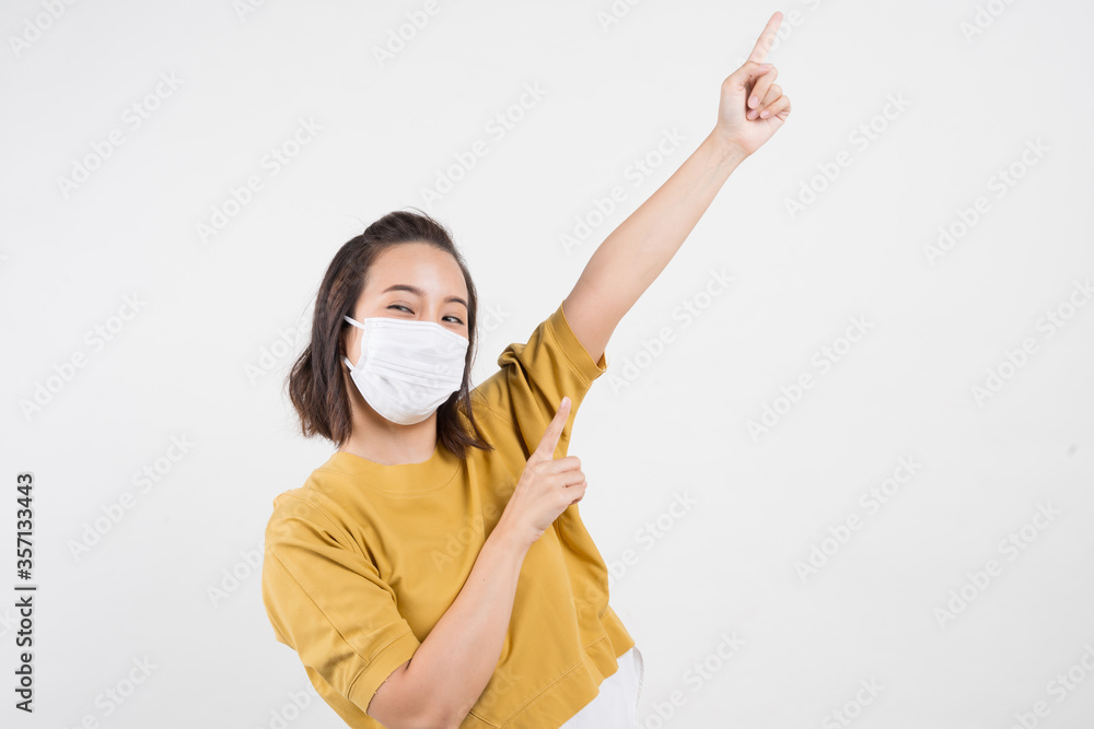 Young Asian woman wearing hygienic mask to prevent infection corona virus Air pollution pm2.5 she wearing a yellow T-shirt shoot in shot isolated on white background Young Asian woman wearing hygienic mask to prevent infection corona virus Air pollution pm2.5 she wearing a yellow T-shirt shoot in shot isolated on white background