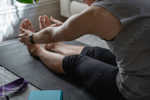 Yoga at home  healthy woman exercising and doing yoga in private room at home. 